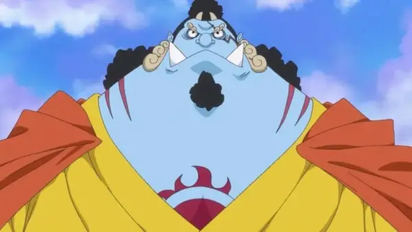 Jinbe rynkar pannan när han står mot den blå himlen