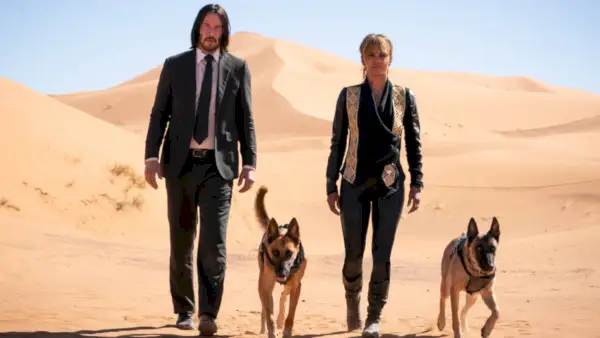 John Wick (Keanu Reeves) y Sofia Al-Azwar (Halle Berry) caminando por un desierto en