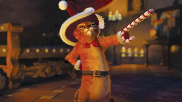 El Gato con Botas lleva un gorro de Papá Noel y blande un bastón de caramelo como si fuera una espada.