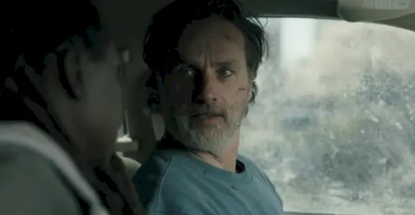 Rick Grimes kijkt naar Michonne in een auto waarin hij niet kan rijden