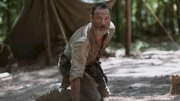 Een gewonde Rick Grimes die worstelt om weg te komen van wandelaars in seizoen 9 van The Walking Dead